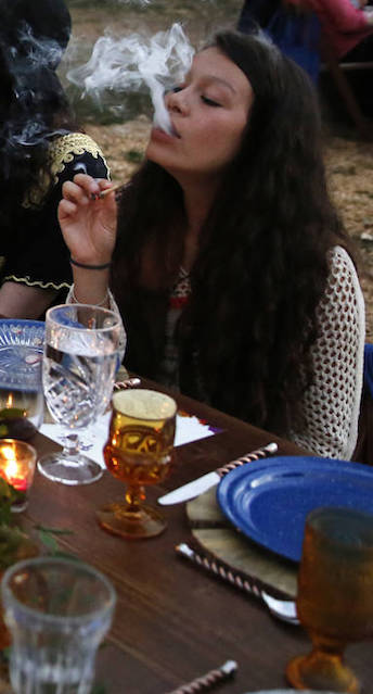 PLEASE HOLD FOR STORY -- In this Oct. 2, 2016 photo, diners eat dishes prepared by chefs and smoke marijuana, during an evening of pairings of fine food and craft marijuana strains served to invited guests dining at Planet Bluegrass, an outdoor venue in Lyons, Colo. (AP Photo/Brennan Linsley)